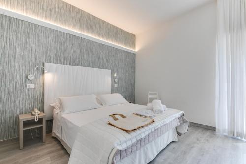 Letto o letti in una camera di MARITTIMO Milano Marittima