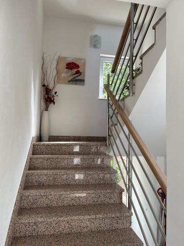 a staircase in a house with a vase of flowers at Apartments Nevenka i Josko in Tučepi