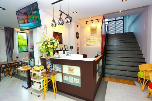 a coffee shop with a counter and a staircase at My Memory Mueang Loei in Loei