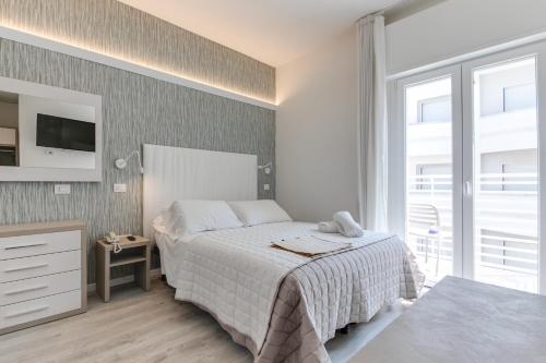Letto o letti in una camera di MARITTIMO Milano Marittima