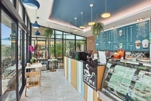 a fast food restaurant with a counter and tables at Dome Kata Resort in Kata Beach