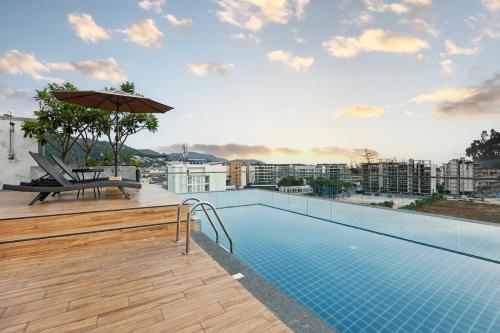 a swimming pool on the roof of a building at Dome Kata Resort in Kata Beach