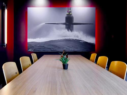 a table in a room with a picture of a submarine at ibis budget Brest Centre Port in Brest