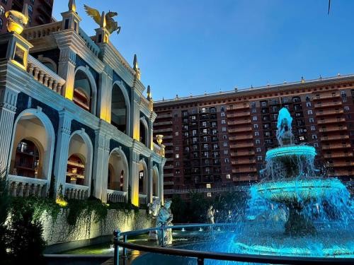 a fountain in front of a building with a building at Апартаменты в ЖК Green Plaza с джакузи in Aktau