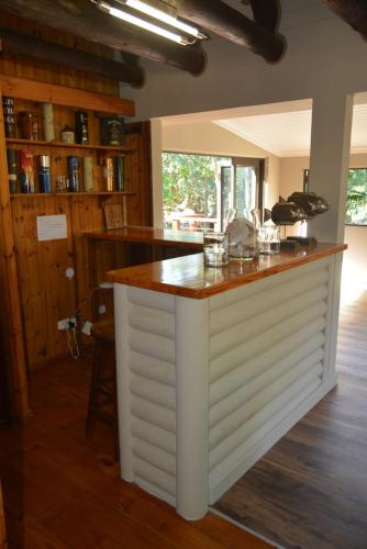 a kitchen with a white island in a room at Sodwana Bay Lodge House 58 in Sodwana Bay