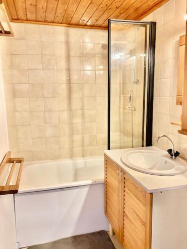 une salle de bain avec une baignoire, un lavabo et une douche dans l'établissement Maison calme proche mer avec piscine, à Bretignolles-sur-Mer