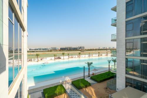 an overhead view of a large swimming pool in a building at Your Keys Holiday Homes in Dubai