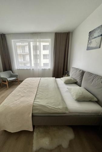 a large bed in a bedroom with a window at MT Suites ApartHotel in Budapest