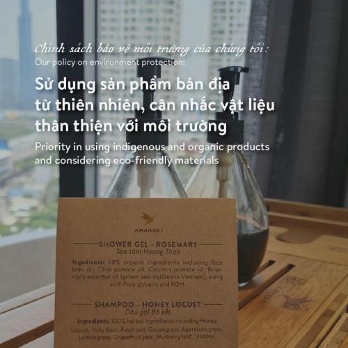 a glass of wine sitting on a table with a sign at Amanaki Thao Dien in Ho Chi Minh City