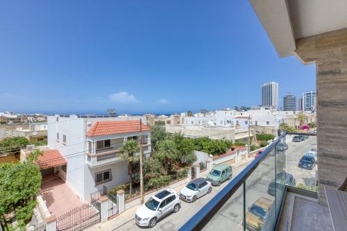 a view of a city with cars parked on a street at Lavish 3bed In Fair Water Homes Swieqi By Homely in Is-Swieqi