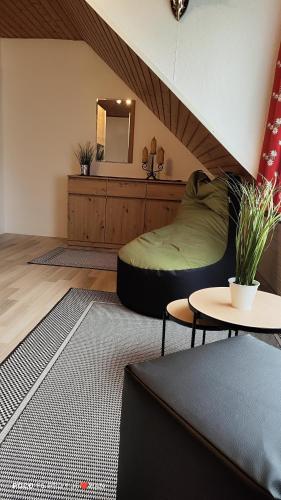 a living room with a bean bag chair and a mirror at Ferienhaus Strassgartl in Pinsdorf
