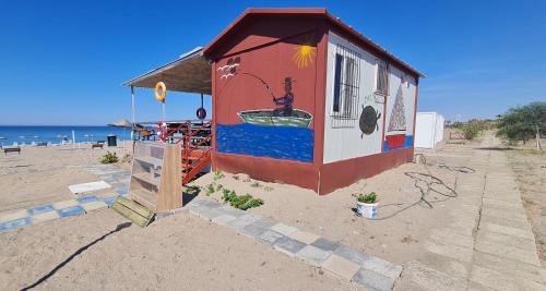 a small shack with a painting on it on the beach at Triblex Villa I Private Beach I Walking Distance to the Sea 300 meters in Side