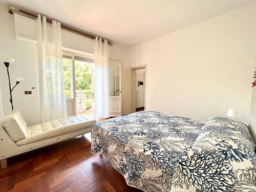 a bedroom with a bed and a window at Pineta Apartament in Tirrenia