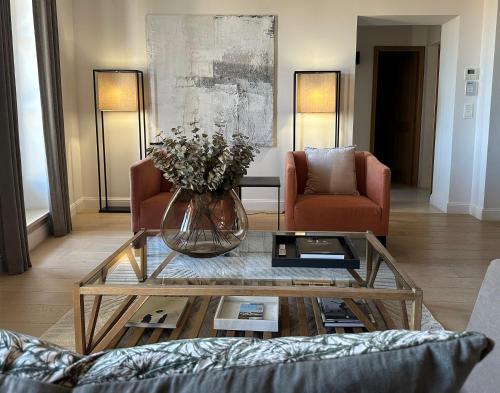 a living room with a vase of flowers on a coffee table at Mougins Luxury Retreats in Mougins