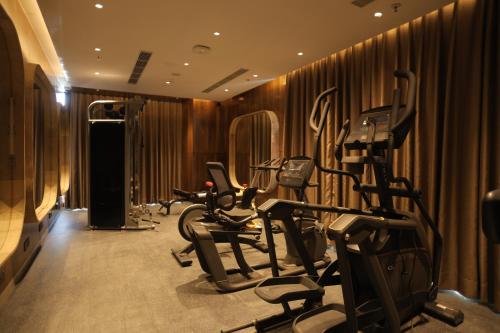 a gym with several exercise bikes and treadmills at Ramada by Wyndham Gorakhpur Gorakhnath Mandir Road in Gorakhpur