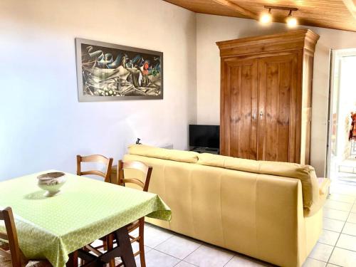 a living room with a couch and a table at Maison en pierre au Lac du Jaunay in Saint-Julien-des-Landes