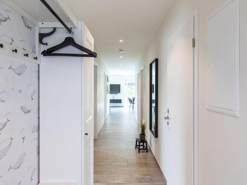 a hallway of a house with white walls and wooden floors at Apartment Fischer sien Huus-2 by Interhome in Fedderwarderdeich
