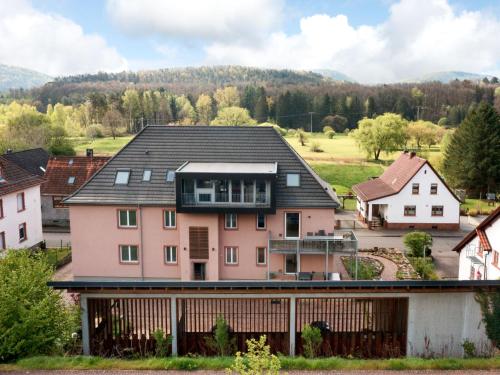 a pink house with a black roof at Apartment Altes Zollhaus-3 by Interhome in Fischbach bei Dahn