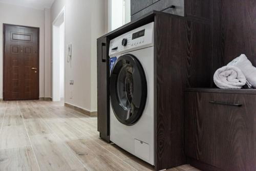 a washer and dryer in a room at City Escape Apartment in Shkodër