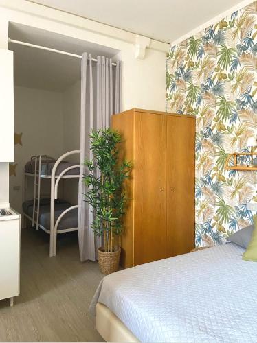 a bedroom with a bed and a cabinet with a plant at Residence Intur in Marciana Marina