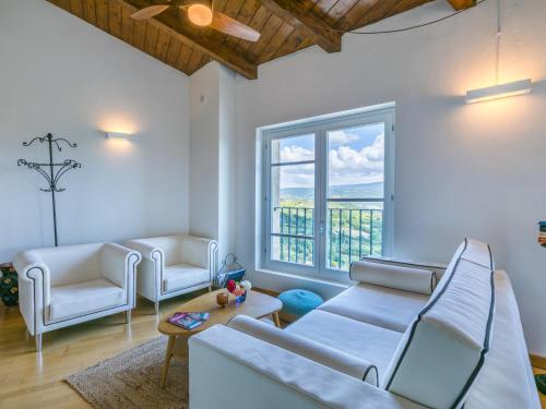 a living room with white furniture and a large window at Apartment Casa del Sole by Interhome in Castelnuovo dellʼAbate