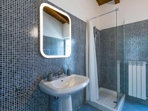 a bathroom with a sink and a mirror and a shower at Apartment Casa del Sole by Interhome in Castelnuovo dellʼAbate