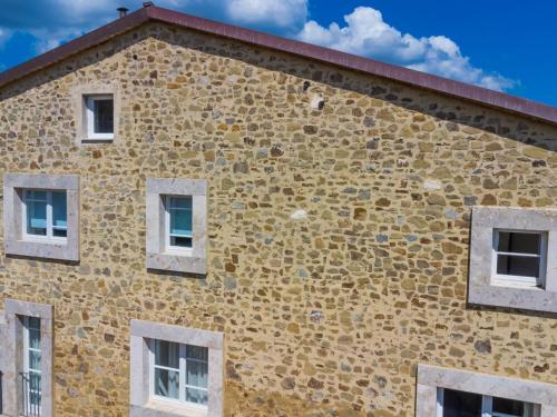an old brick building with windows on the side at Apartment Casa del Sole by Interhome in Castelnuovo dellʼAbate