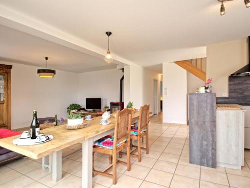 a kitchen and living room with a wooden table and chairs at Holiday Home Chez Lucie by Interhome in Camlez