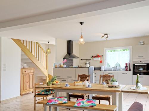 a kitchen with a wooden table and chairs at Holiday Home Chez Lucie by Interhome in Camlez