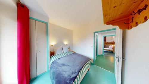 a bedroom with a bed and a room with a mirror at Les Neiges in Saint-Sorlin-dʼArves