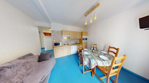 a kitchen and dining room with a table and a couch at Les Neiges in Saint-Sorlin-dʼArves