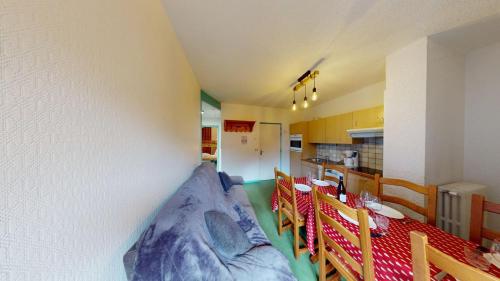 a room with a bed in the corner of a kitchen at Les Neiges in Saint-Sorlin-dʼArves