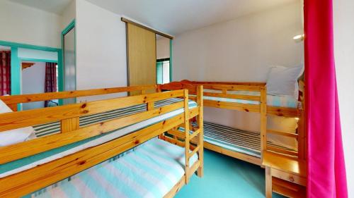 a room with two bunk beds in a house at Les Neiges in Saint-Sorlin-dʼArves