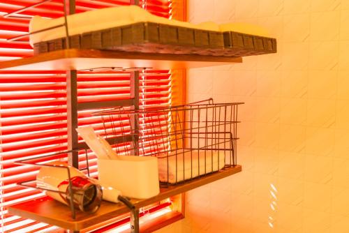 a shelf with a bird cage on a wall at クラレンス-森の中でBBQと4Kプロジェクターが楽しめる北軽井沢の貸切Villa- in Kita-karuizawa