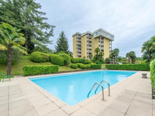 a swimming pool in front of a building at Apartment Euroville-1 by Interhome in Germignaga