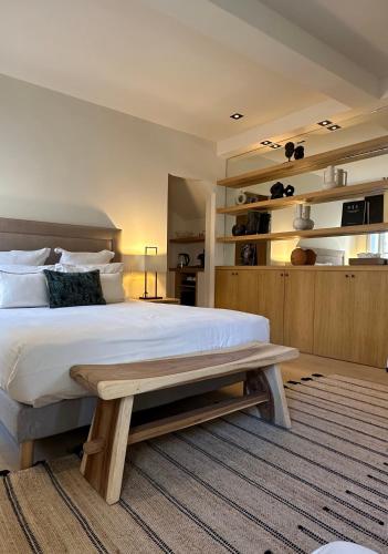 a bedroom with a large bed and a bench at Mougins Luxury Retreats in Mougins