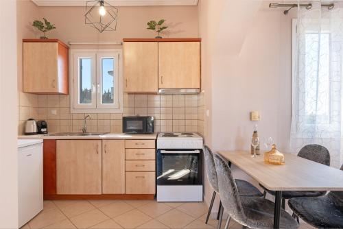 a kitchen with a table and a stove top oven at Spiros house in Svoronata