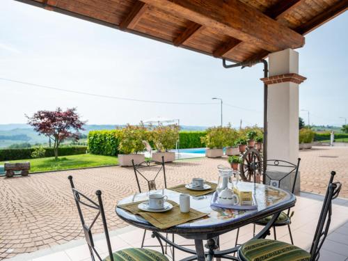 a table and chairs on the patio of a house at Holiday Home Collina San Ponzio by Interhome in Barolo