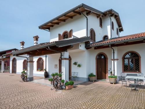 a courtyard of a house with a table and chairs at Holiday Home Collina San Ponzio by Interhome in Barolo