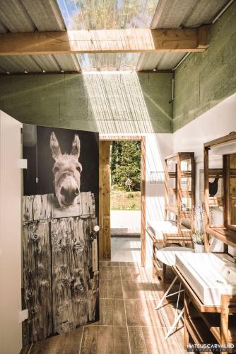 a room with a painting of a moose head on the wall at Logement insolite L'heureux hasard - van vintage in Contres