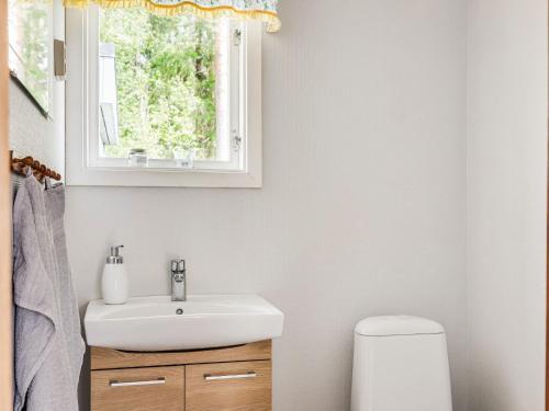 a bathroom with a sink and a window at Holiday Home Sjöatorp Skogsstugan by Interhome in Hjortsberga