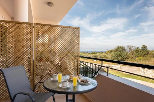 a table on a balcony with a view of the ocean at Spiros house in Svoronata