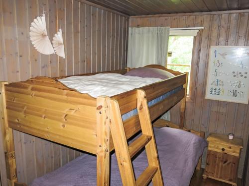 a bedroom with a wooden bunk bed in a cabin at Holiday Home Hustjønn by Interhome in Aamli