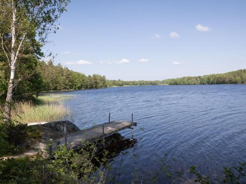 a lake with a dock in the middle of it at Holiday Home Munkhalla Utsikten by Interhome in Asarum