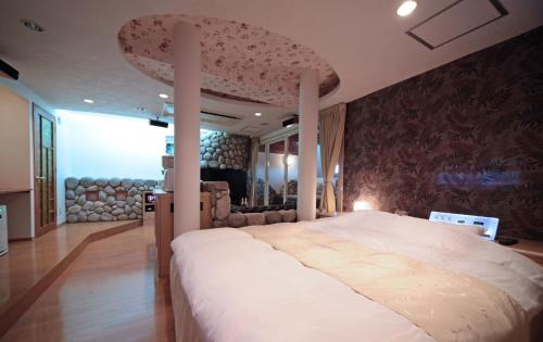 a bedroom with a large bed in a room at hotel SWEET SEASON in Hashima
