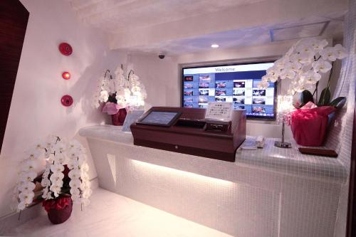 a flower shop with a display case with flowers at hotel SWEET SEASON in Hashima
