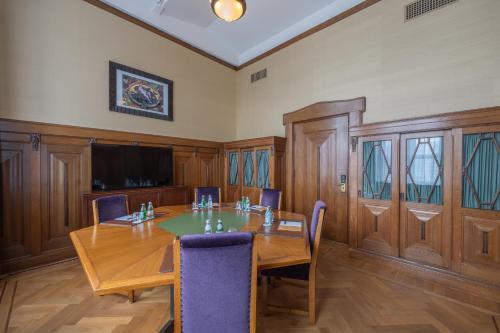 a conference room with a wooden table and chairs at Grand Hotel Amrâth Amsterdam in Amsterdam