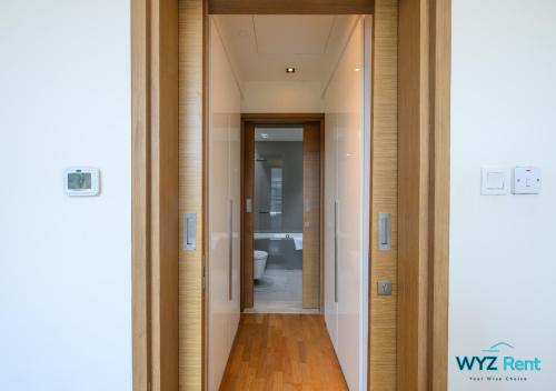 a hallway leading to a bathroom with a toilet at The perfect CityWalk 1 BR in the heart of Dubai in Dubai
