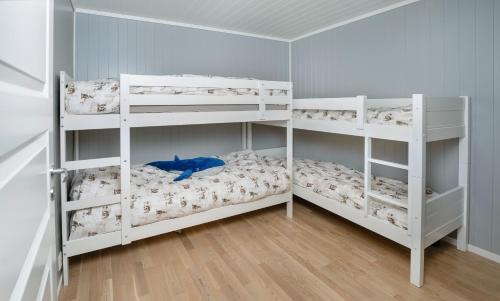 two white bunk beds in a room at Voss Resort self-service apartments in Skulestadmo