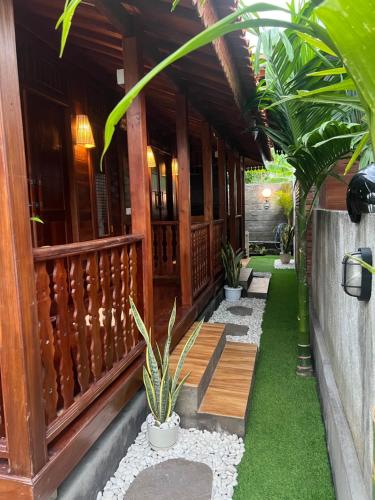 a porch of a house with plants on it at ADIKARA TROPICAL GARDEN in Gianyar